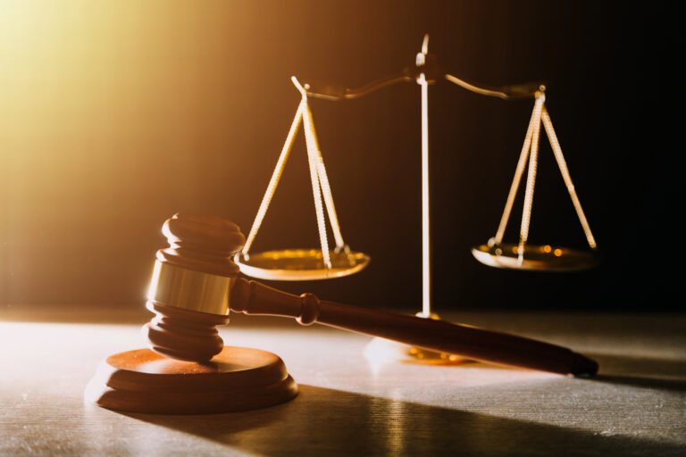 business and lawyers discussing contract papers with brass scale